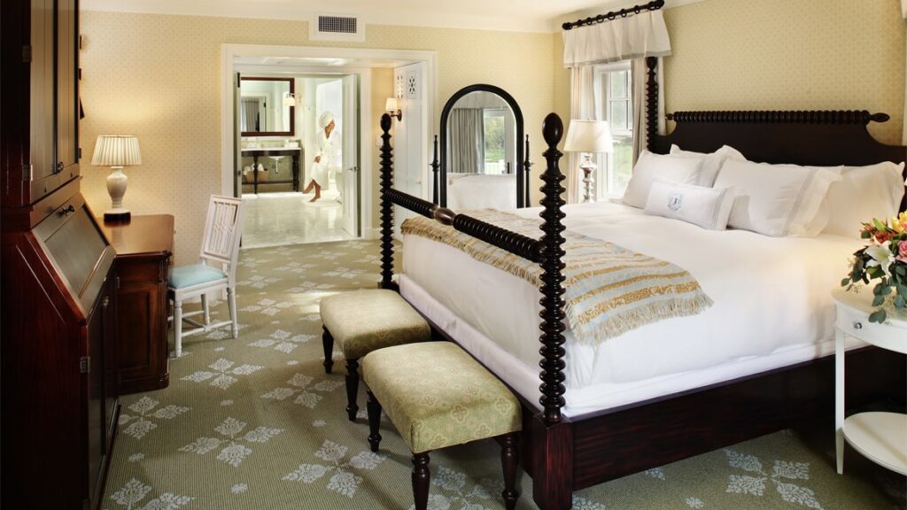 Omni Bedford Springs Resort bedroom with woman in robe at one of the best luxury resorts in Pennsylvania